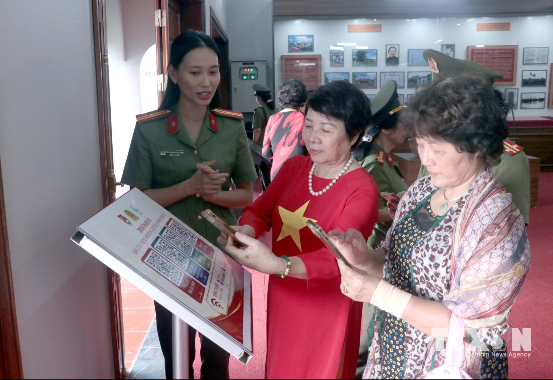Người dân quét mã QR để tim hiểu thông tin tại Khu lưu niệm Anh hùng liệt sĩ Công an nhân dân Bùi Thị Cúc xã Xuân Trúc. (Ảnh: Đinh Văn Nhiều/TTXVN)